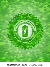 battery charging icon inside green emblem with mosaic ecological style background