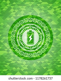 battery charging icon inside green emblem with mosaic ecological style background