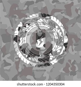 battery charging icon inside grey camouflaged emblem