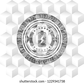 battery charging icon inside grey emblem with geometric cube white background