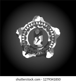 battery charging icon inside grey camouflage texture