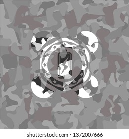 battery charging icon inside grey camo emblem