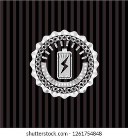 battery charging icon inside silvery badge or emblem