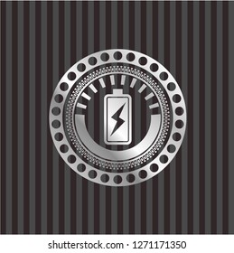 battery charging icon inside silvery emblem or badge