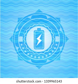 battery charging icon inside sky blue water wave emblem background.