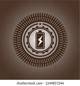 battery charging icon inside wooden emblem