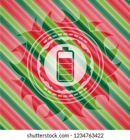 battery icon inside christmas style emblem.