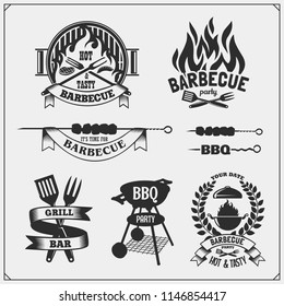 BBQ and grill labels set. Barbecue emblems, badges and design elements. Vector monochrome illustration.