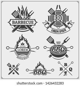 BBQ and grill labels set. Barbecue emblems, badges and design elements. Vector monochrome illustration.