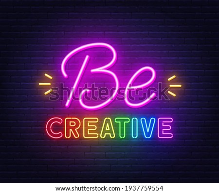 Be creative neon inspirational quote on a brick wall.