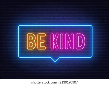 Be Kind neon sign on brick wall background.
