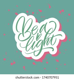 Be a Light. Green inscription on a colored background. Great lettering and calligraphy for greeting cards, stickers, banners, prints and home interior decor.