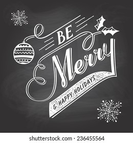 Be Merry. Hand-lettering Christmas greeting label on blackboard with chalk