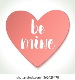 Be Mine modern calligraphy on pink heart background. Valentine's day card template. Brush painted letters, vector illustration.