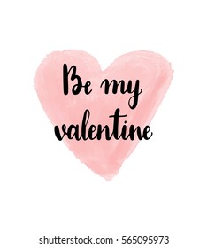 Be my valentine hand drawn lettering on watercolor heart. 