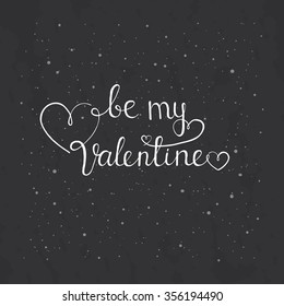 Be my Valentine. Hand written lettering on the blackboard.