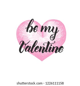 Be my Valentine - Handwritten inspirational and motivational quote with pink hand made heart isolated on white. Lettering calligraphy phrase. Happy Valentine's Day.