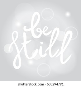 Be still Lettering phrase. Hand drawn motivation and inspiration quote. White letters on gray blured background. Artistic design element for poster, banner. Calligraphy print. Vector illustration.