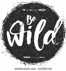 Be Wild hand drawing brush pen grunge texture inscription with arrows and round background.