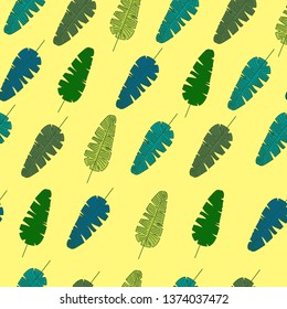 Beach cheerful pattern wallpaper of tropical dark green leaves of palm trees  on a light yellow background