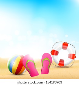 Beach with flip-flops, beach ball and safety circle