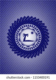 beach icon inside badge with denim texture