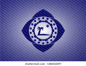 beach icon inside badge with denim background