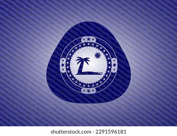 beach icon inside badge with denim background. 