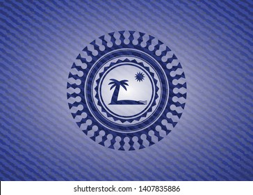 beach icon inside emblem with denim texture