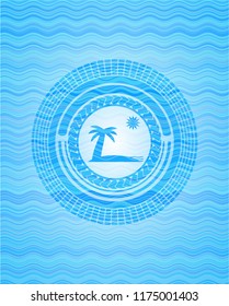 beach icon inside light blue water wave badge background.
