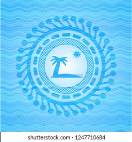 beach icon inside light blue water wave emblem.