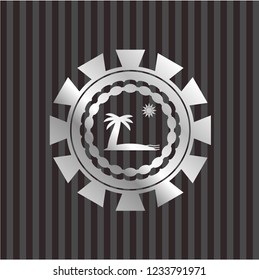 beach icon inside silvery badge or emblem