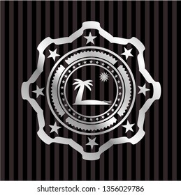beach icon inside silvery badge or emblem