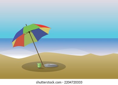 A beach and the sea landscape with a colorful parasol and a toy bucket under it. The sea is flat and the sky is blue. 