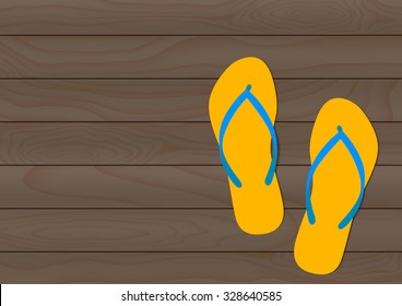 Beach slipper on wood grain background