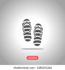 Beach slippers. Flip flops icon. Icon under spotlight. Gray background