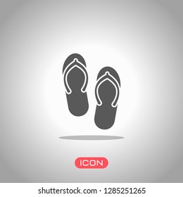 Beach slippers. Flip flops icon. Icon under spotlight. Gray background