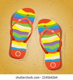 Beach slippers on sand.