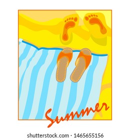 Beach towel and flip flops on a yellow sand