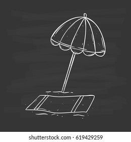 beach umbrella on the sand using doodle art with chalkboard background