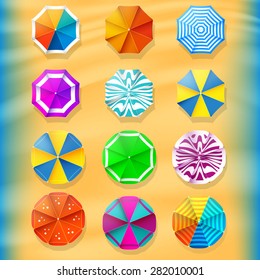 Beach umbrellas top view icons. On the background of the beach