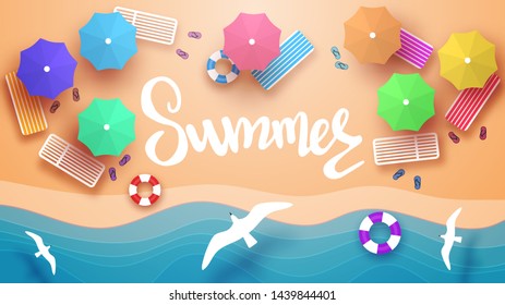 Beach view from the top. Sunbeds, umbrellas, inflatable circles for swimming, beach Slippers. Flying seagulls. Sea wave. sandy beach.