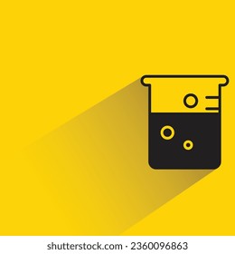 beaker with shadow on yellow background