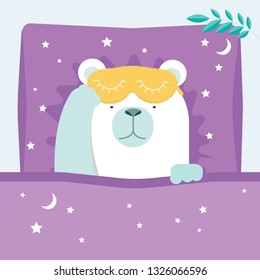 The bear is in bed with a sleep mask