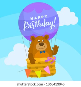 Bear with bow tie inside happy birthday hot air balloon with blue sky background