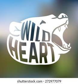 Bear head silhouette with text wild heart on blur background. Vector illustration