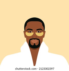 Bearded african man in a white bathrobe with gold eye patches on his face. Daily skincare routine