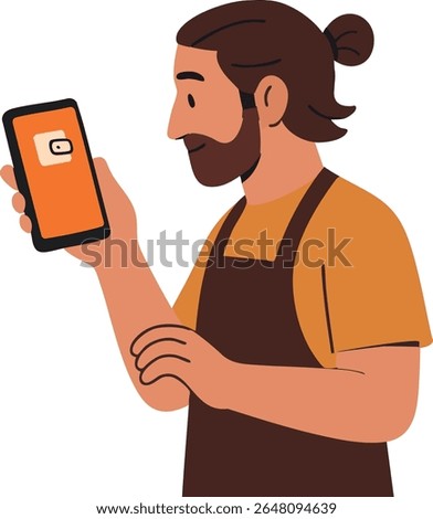 A bearded man in a brown apron and orange shirt is looking at a smartphone with a cheerful expression, suggesting he is checking something related to work or a message.