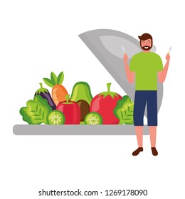 bearded man with fresh vegetables and fork knife