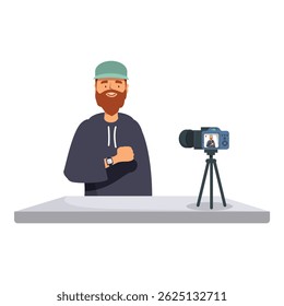 Bearded man in hoodie recording a vlog using a camera on a tripod